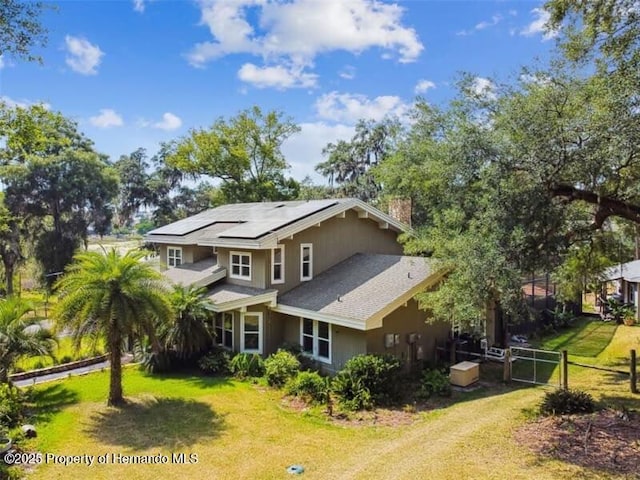 39127 Pretty Pond Rd, Zephyrhills, FL 33540 - view of front of home with solar panels, dirt driveway, and a chimney