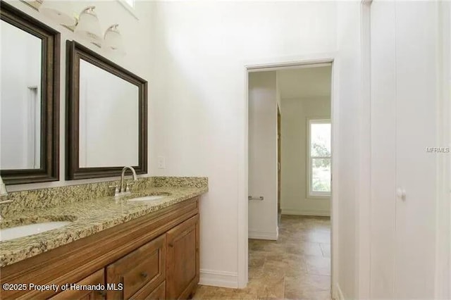 39127 Pretty Pond Rd, Zephyrhills, FL 33540 - bathroom with double vanity and baseboards
