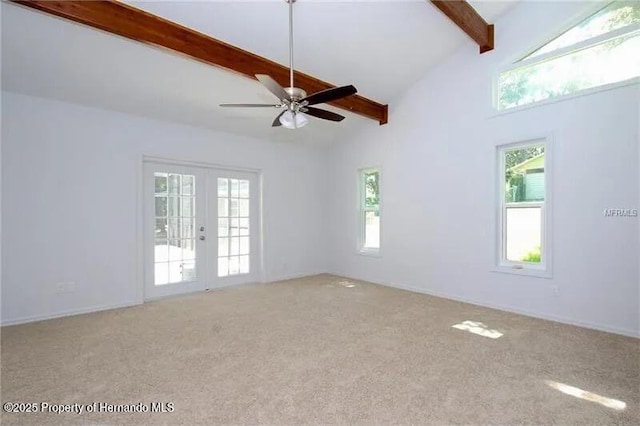 39127 Pretty Pond Rd, Zephyrhills, FL 33540 - empty room featuring beamed ceiling, carpet, healthy amount of natural light, french doors, and high vaulted ceiling