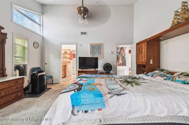 39127 Pretty Pond Rd, Zephyrhills, FL 33540 - bedroom featuring a towering ceiling, carpet flooring, a walk in closet, connected bathroom, and a ceiling fan