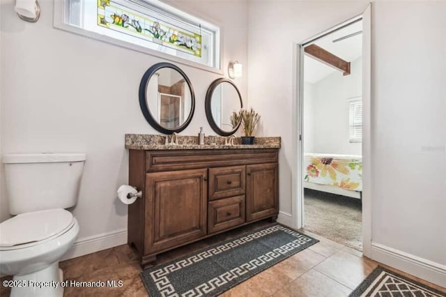 39127 Pretty Pond Rd, Zephyrhills, FL 33540 - bathroom with vanity, toilet, baseboards, and connected bathroom