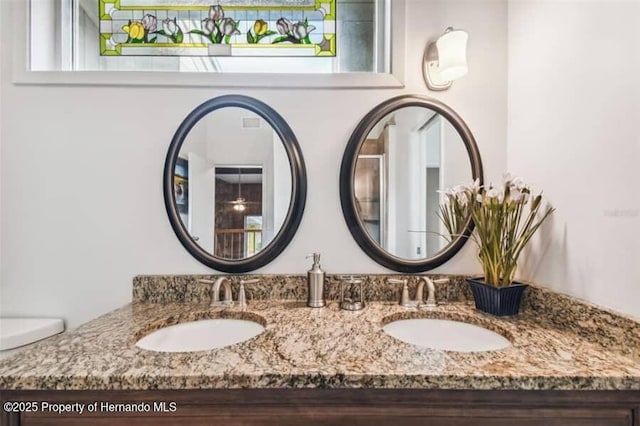 39127 Pretty Pond Rd, Zephyrhills, FL 33540 - bathroom with double vanity and toilet