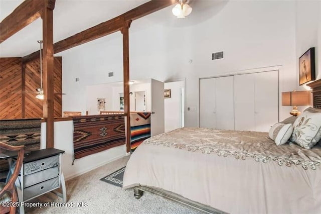 39127 Pretty Pond Rd, Zephyrhills, FL 33540 - carpeted bedroom with high vaulted ceiling, a closet, beamed ceiling, and ceiling fan