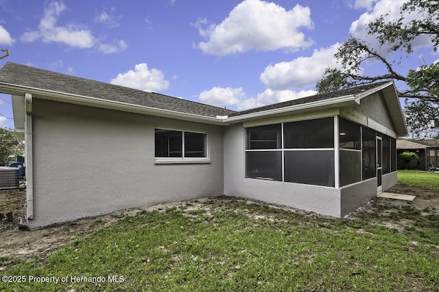 13406 Banyan Rd, Spring Hill, FL 34609 - view of home's exterior featuring a sunroom, stucco siding, and a lawn