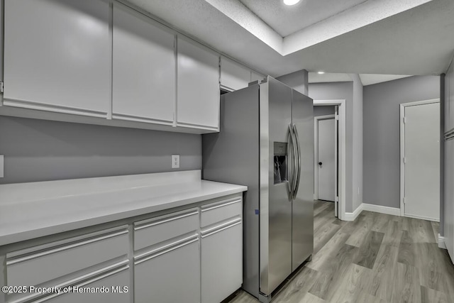 13406 Banyan Rd, Spring Hill, FL 34609 - kitchen featuring stainless steel refrigerator with ice dispenser, light wood-style flooring, baseboards, light countertops, and recessed lighting