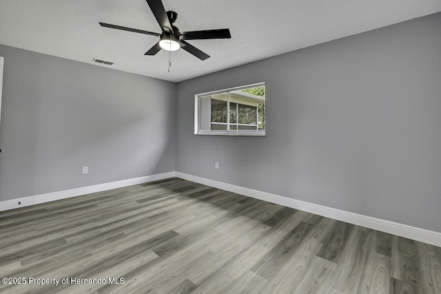 13406 Banyan Rd, Spring Hill, FL 34609 - unfurnished room featuring wood finished floors, baseboards, and a ceiling fan