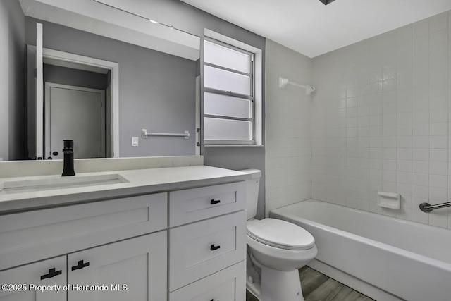 13406 Banyan Rd, Spring Hill, FL 34609 - bathroom with vanity, toilet, tub / shower combination, and wood finished floors