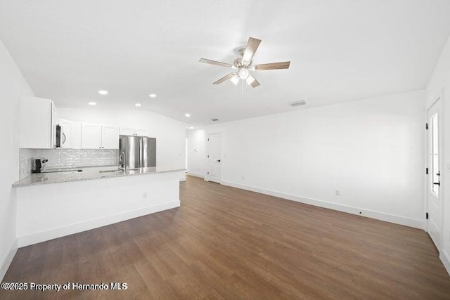 14376 Earline Ave, Weeki Wachee, FL 34614 - unfurnished living room with ceiling fan, recessed lighting, dark wood-type flooring, baseboards, and vaulted ceiling