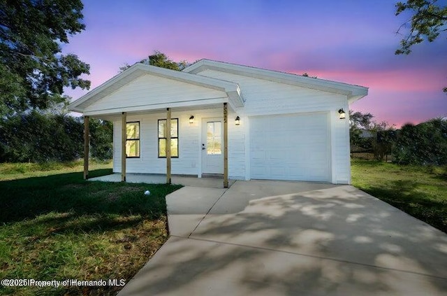 14376 Earline Ave, Weeki Wachee, FL 34614 - ranch-style home featuring a porch, a garage, concrete driveway, and a front lawn