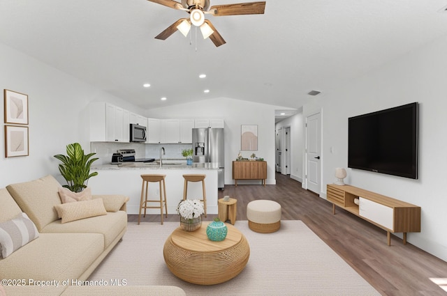 14376 Earline Ave, Weeki Wachee, FL 34614 - living room featuring recessed lighting, wood finished floors, lofted ceiling, and ceiling fan