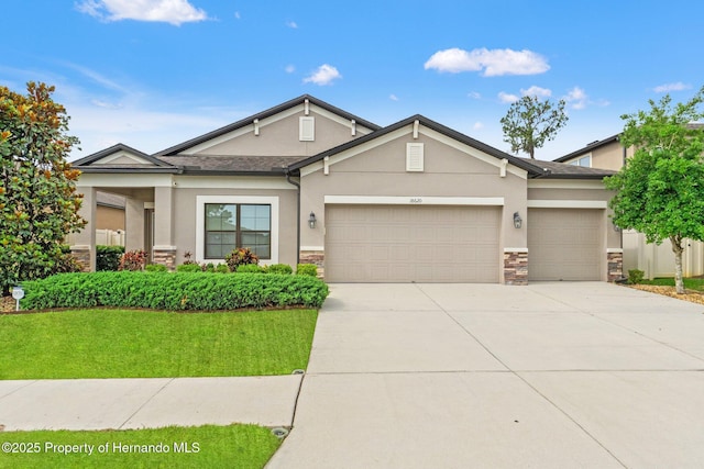 18620 Rococo Rd, Spring Hill Pasco, FL 34610 - view of front facade with stone siding, a garage, driveway, stucco siding, and a front yard