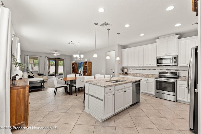 18620 Rococo Rd, Spring Hill Pasco, FL 34610 - kitchen featuring stainless steel appliances, a sink, light tile patterned flooring, decorative backsplash, and recessed lighting