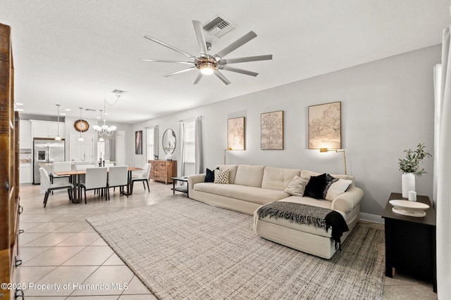 18620 Rococo Rd, Spring Hill Pasco, FL 34610 - living area featuring ceiling fan, light tile patterned floors, baseboards, and a chandelier