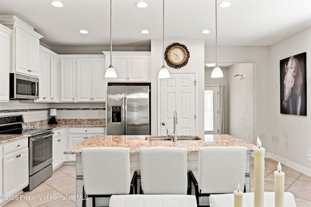 18620 Rococo Rd, Spring Hill Pasco, FL 34610 - kitchen with stainless steel appliances, a sink, light tile patterned floors, white cabinets, and recessed lighting