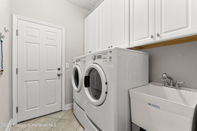 18620 Rococo Rd, Spring Hill Pasco, FL 34610 - washroom featuring cabinet space, washing machine and clothes dryer, light tile patterned floors, and baseboards