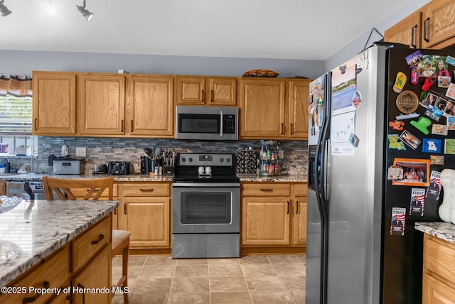 10457 Cranston St, Spring Hill, FL 34608 - kitchen with appliances with stainless steel finishes, tasteful backsplash, and light stone countertops