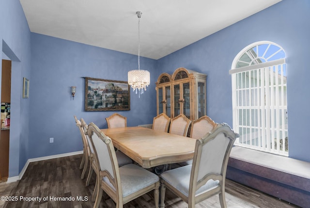 10457 Cranston St, Spring Hill, FL 34608 - dining area featuring a chandelier, wood finished floors, plenty of natural light, and baseboards