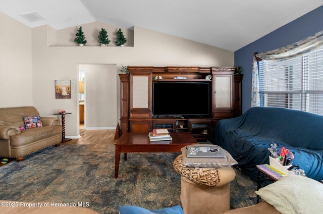 10457 Cranston St, Spring Hill, FL 34608 - living area featuring lofted ceiling, wood finished floors, and baseboards