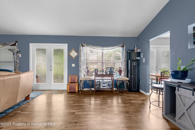 10457 Cranston St, Spring Hill, FL 34608 - living room featuring french doors, wood finished floors, vaulted ceiling, and baseboards