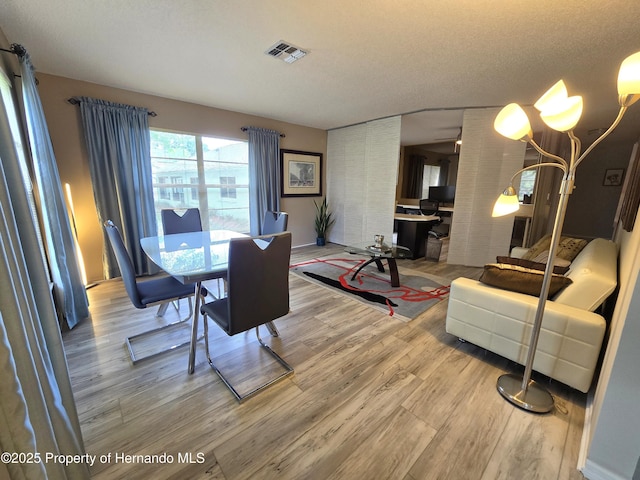 2429 Birdie Ln, Spring Hill, FL 34606 - dining room featuring wood finished floors and a chandelier
