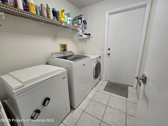 2429 Birdie Ln, Spring Hill, FL 34606 - laundry area featuring washing machine and dryer and light tile patterned flooring