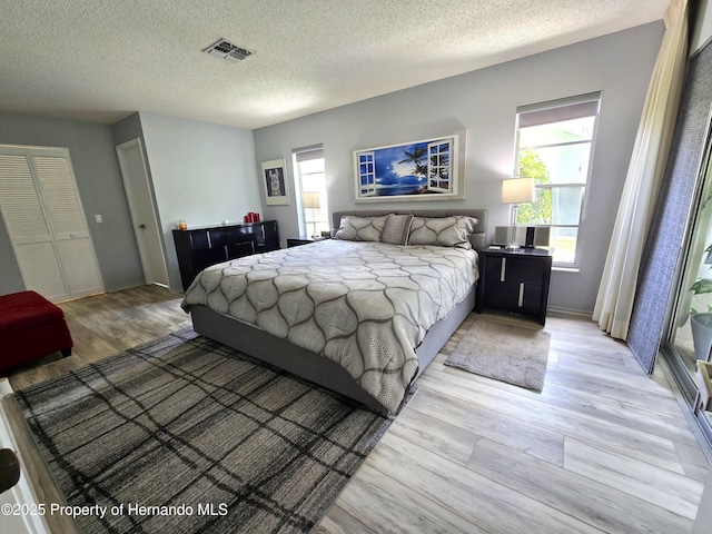2429 Birdie Ln, Spring Hill, FL 34606 - bedroom featuring light wood-style flooring and a textured ceiling