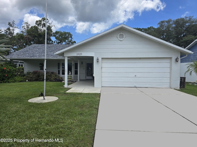 2429 Birdie Ln, Spring Hill, FL 34606 - ranch-style home with a front lawn, an attached garage, driveway, and brick siding