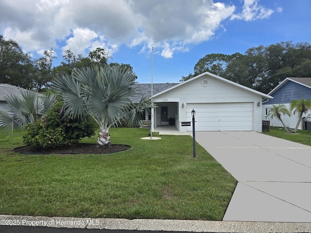 2429 Birdie Ln, Spring Hill, FL 34606 - view of front of home featuring a garage, concrete driveway, and a front yard