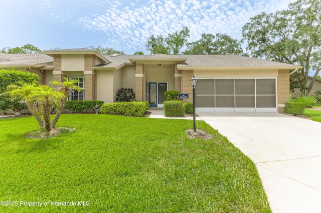 2481 Whispering Pines Ct, Spring Hill, FL 34606 - view of front of property featuring an attached garage, driveway, brick siding, and a front yard
