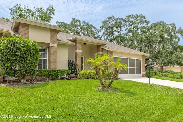 2481 Whispering Pines Ct, Spring Hill, FL 34606 - view of front of property featuring driveway, a front lawn, brick siding, a garage, and a shingled roof