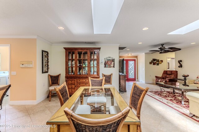 2481 Whispering Pines Ct, Spring Hill, FL 34606 - dining space with a skylight, recessed lighting, baseboards, light tile patterned flooring, and crown molding