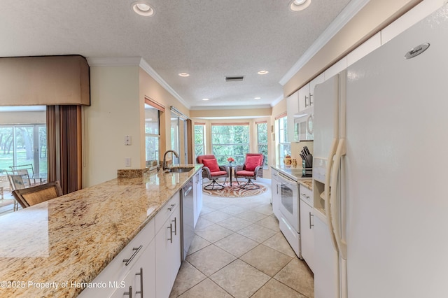2481 Whispering Pines Ct, Spring Hill, FL 34606 - kitchen with white appliances, a sink, plenty of natural light, recessed lighting, and white cabinetry