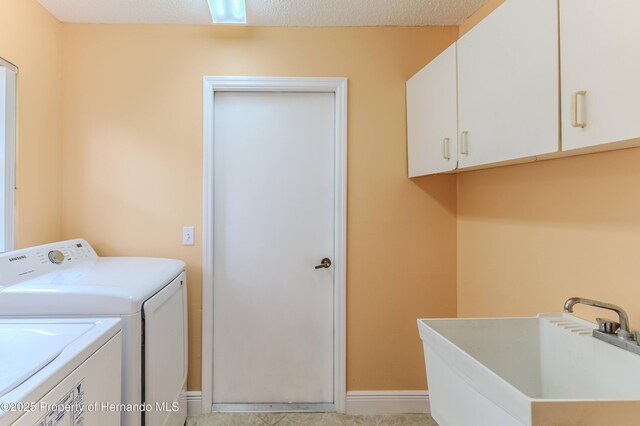 2481 Whispering Pines Ct, Spring Hill, FL 34606 - washroom with washing machine and dryer, cabinet space, and baseboards