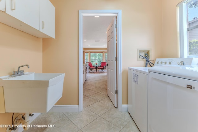 2481 Whispering Pines Ct, Spring Hill, FL 34606 - laundry room with washer and clothes dryer, light tile patterned flooring, cabinet space, baseboards, and recessed lighting