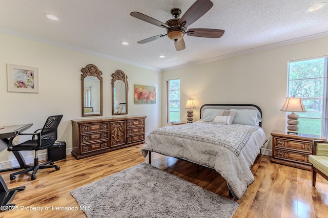 2481 Whispering Pines Ct, Spring Hill, FL 34606 - bedroom featuring multiple windows, a textured ceiling, crown molding, light wood-style floors, and recessed lighting