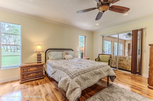 2481 Whispering Pines Ct, Spring Hill, FL 34606 - bedroom with crown molding, a textured ceiling, access to outside, light wood-style flooring, and ceiling fan
