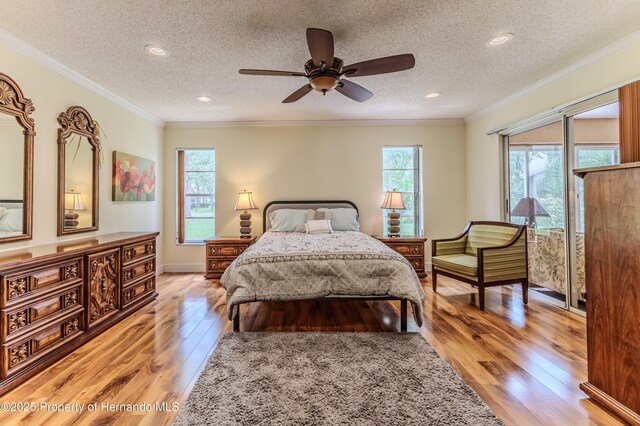 2481 Whispering Pines Ct, Spring Hill, FL 34606 - bedroom with light wood-type flooring, a textured ceiling, ornamental molding, recessed lighting, and a ceiling fan