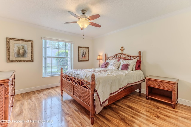 2481 Whispering Pines Ct, Spring Hill, FL 34606 - bedroom with light wood-type flooring, ornamental molding, baseboards, a textured ceiling, and a ceiling fan