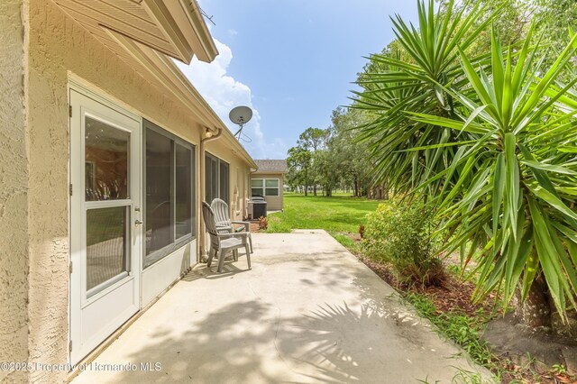 2481 Whispering Pines Ct, Spring Hill, FL 34606 - view of patio / terrace with central air condition unit