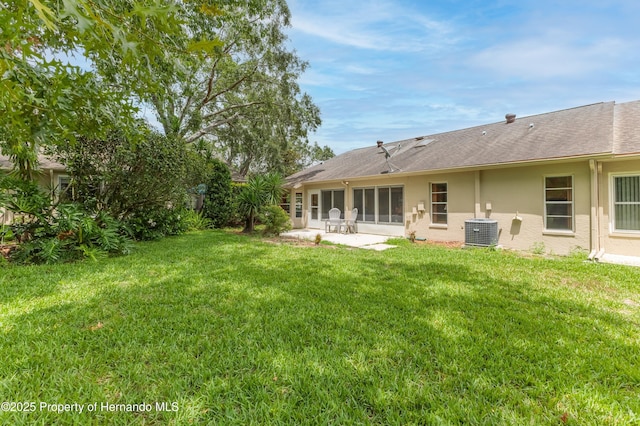 2481 Whispering Pines Ct, Spring Hill, FL 34606 - view of green lawn featuring central AC and a patio