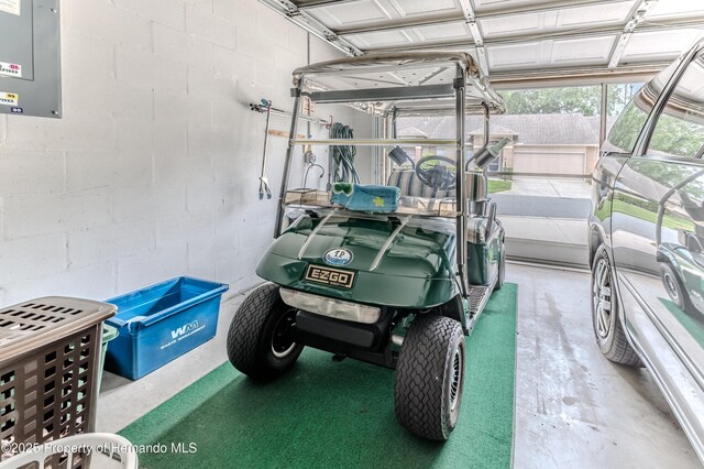 2481 Whispering Pines Ct, Spring Hill, FL 34606 - garage featuring concrete block wall