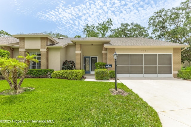 2481 Whispering Pines Ct, Spring Hill, FL 34606 - view of front of house with brick siding, driveway, a garage, and a front lawn