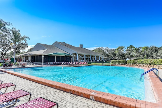2481 Whispering Pines Ct, Spring Hill, FL 34606 - community pool featuring a patio area