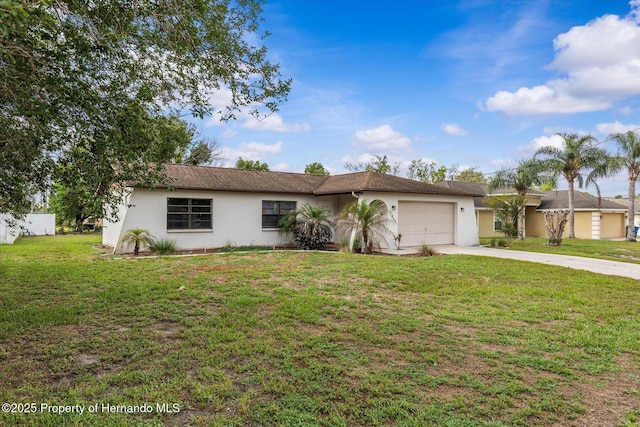 2450 Ambassador Ave, Spring Hill, FL 34609 - single story home with stucco siding, an attached garage, driveway, and a front lawn