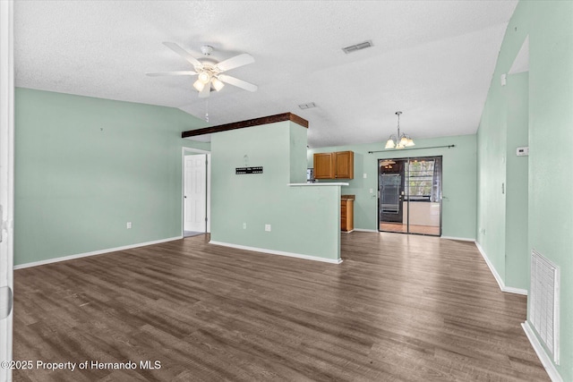 2450 Ambassador Ave, Spring Hill, FL 34609 - unfurnished living room featuring a ceiling fan, a textured ceiling, wood finished floors, baseboards, and a chandelier
