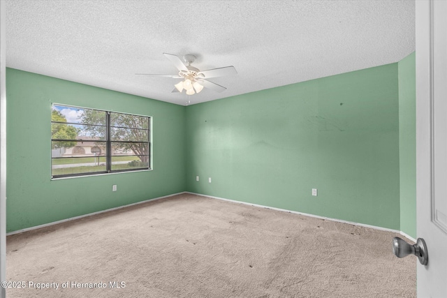 2450 Ambassador Ave, Spring Hill, FL 34609 - carpeted empty room featuring ceiling fan, a textured ceiling, and baseboards