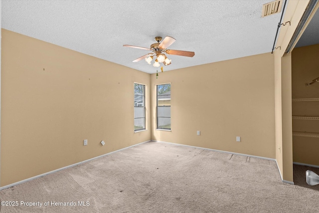 2450 Ambassador Ave, Spring Hill, FL 34609 - carpeted spare room with ceiling fan, a textured ceiling, and baseboards