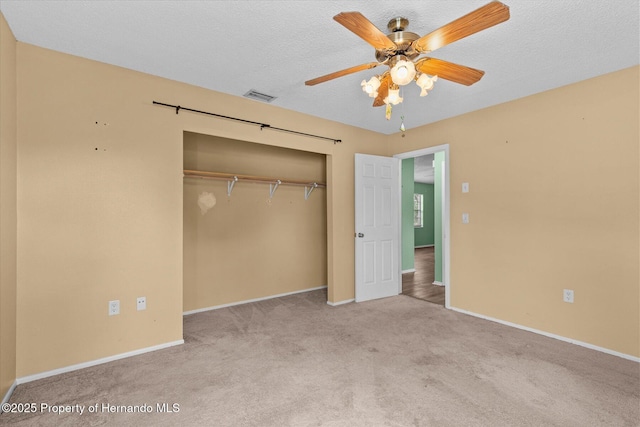 2450 Ambassador Ave, Spring Hill, FL 34609 - unfurnished bedroom with a closet, carpet, baseboards, and ceiling fan