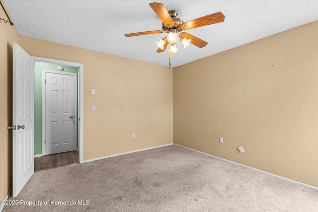 2450 Ambassador Ave, Spring Hill, FL 34609 - empty room featuring carpet flooring, a ceiling fan, baseboards, and a textured ceiling