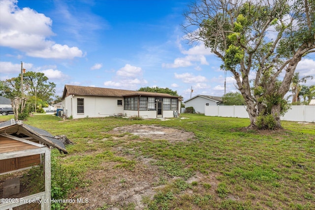 2450 Ambassador Ave, Spring Hill, FL 34609 - back of house with a sunroom and stucco siding